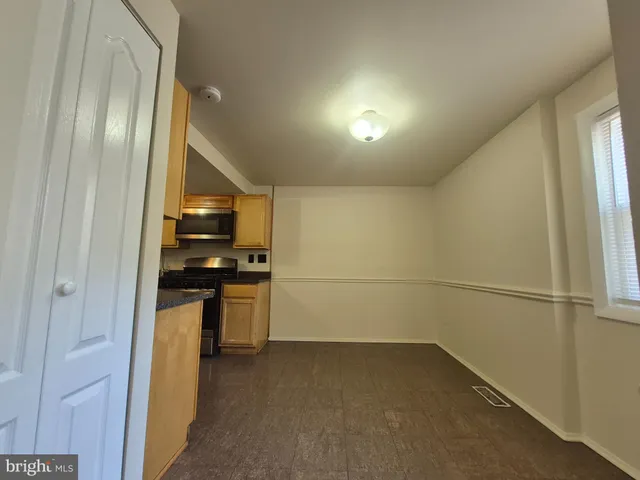a kitchen with stainless steel appliances a refrigerator and a stove