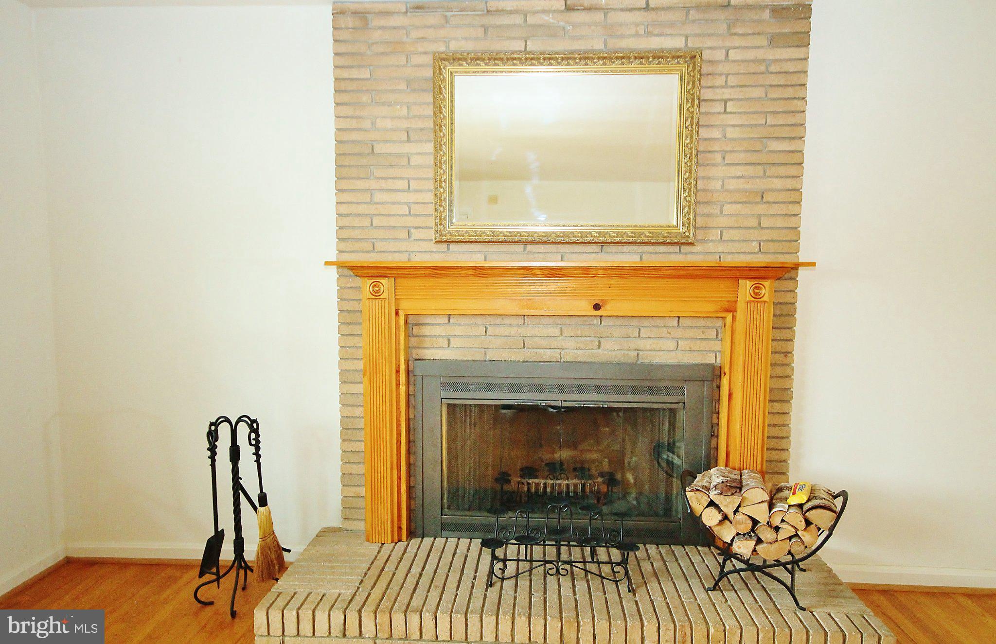 5504 Inverchapel Road Springfield, VA 22151 - Photo 4 of 51 Cozy fireplace with rustic charm.
