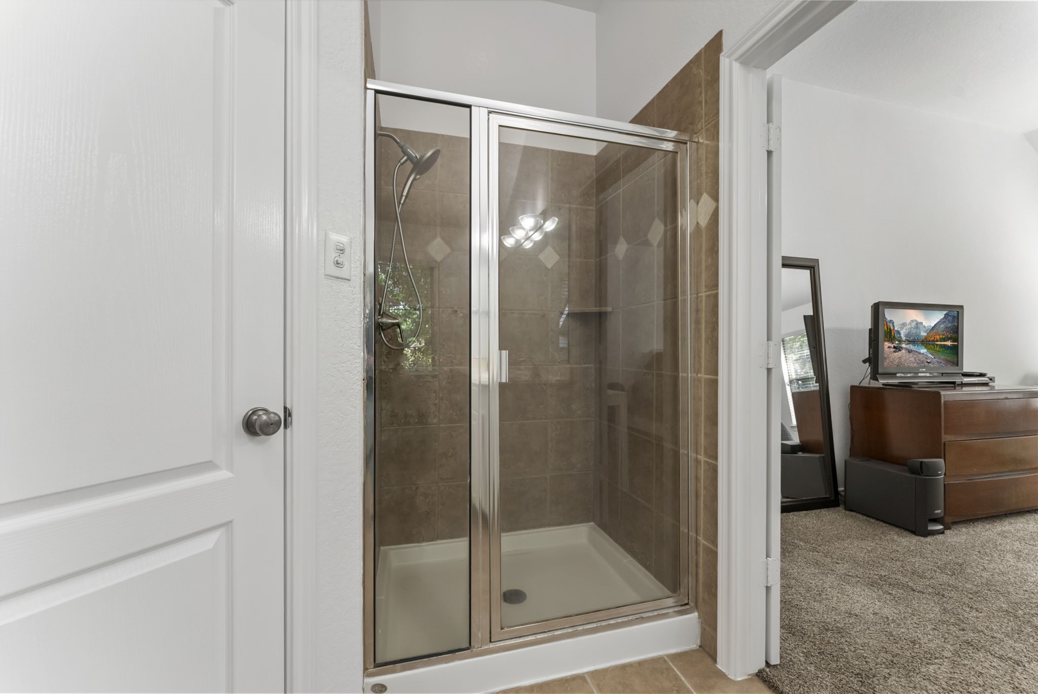 2106 Leaf Meadows Court Spring, TX 77386 - Photo 27 of 34 a bathroom with a glass shower door