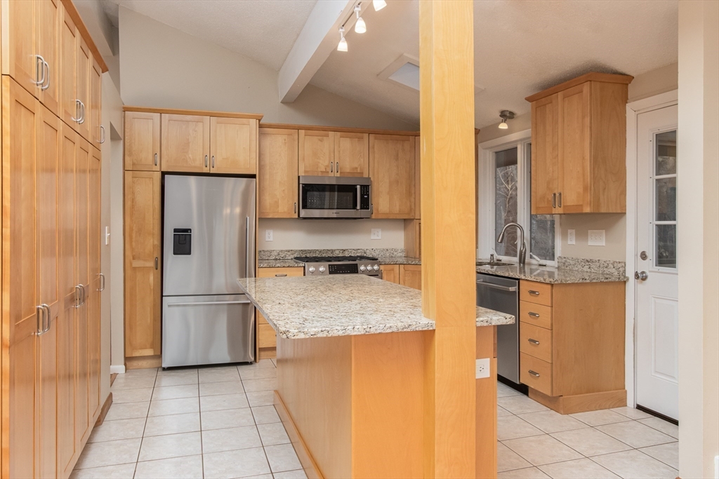 7 No Name Road Stow, MA 01775 - Photo 12 of 42 a kitchen with stainless steel appliances granite countertop a refrigerator and a stove