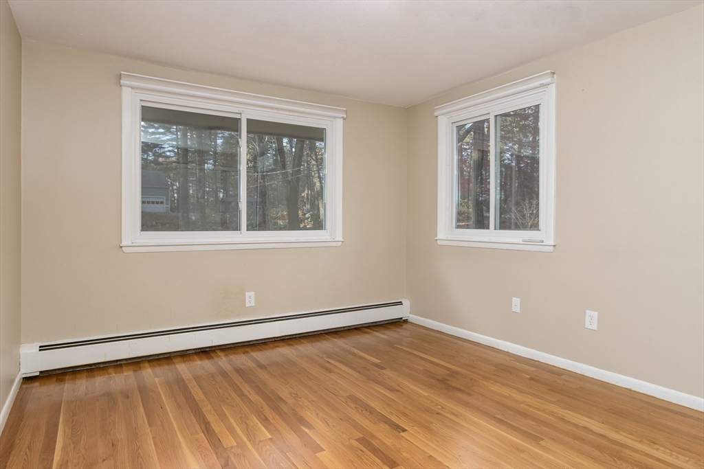 7 No Name Road Stow, MA 01775 - Photo 30 of 42 a view of an empty room with wooden floor and a window