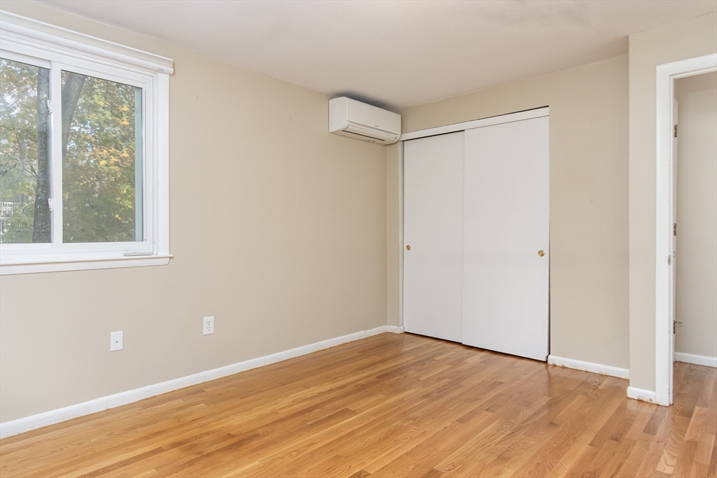 7 No Name Road Stow, MA 01775 - Photo 31 of 42 a view of an empty room with wooden floor and a window