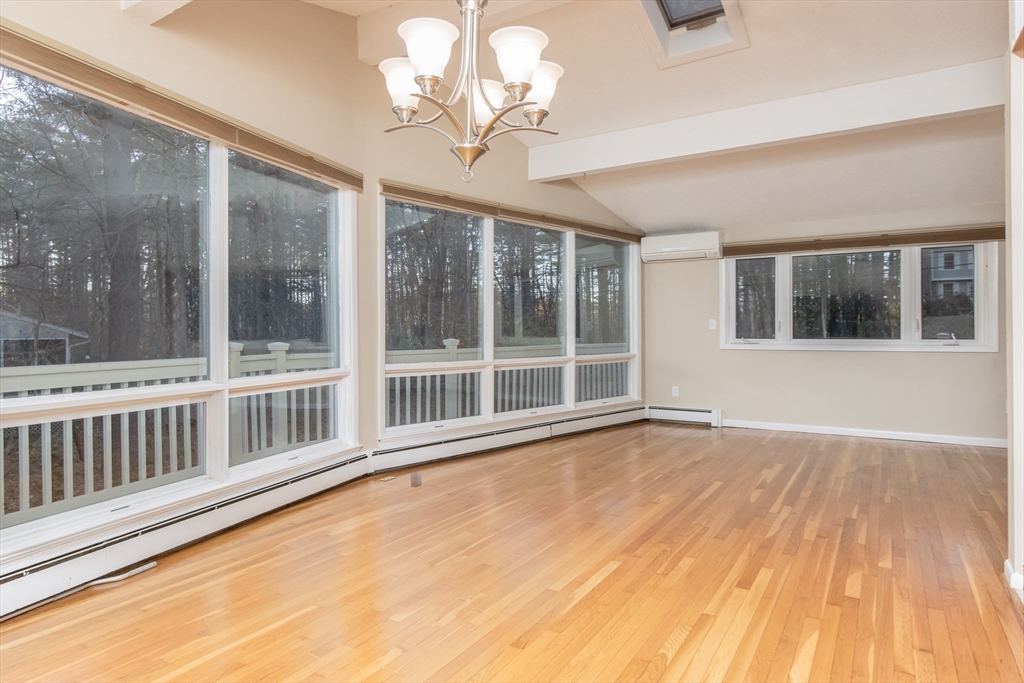 7 No Name Road Stow, MA 01775 - Photo 7 of 42 a view of an empty room with a window and wooden floor
