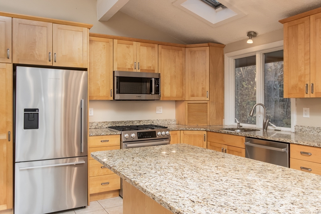 7 No Name Road Stow, MA 01775 - Photo 10 of 42 a kitchen with stainless steel appliances granite countertop a refrigerator stove and microwave