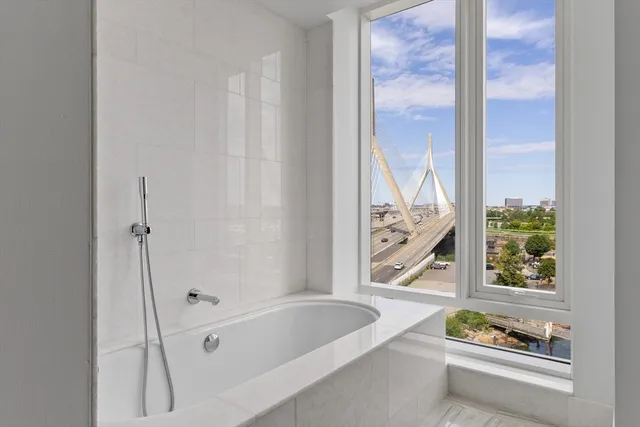 a bathroom with a bathtub and a window