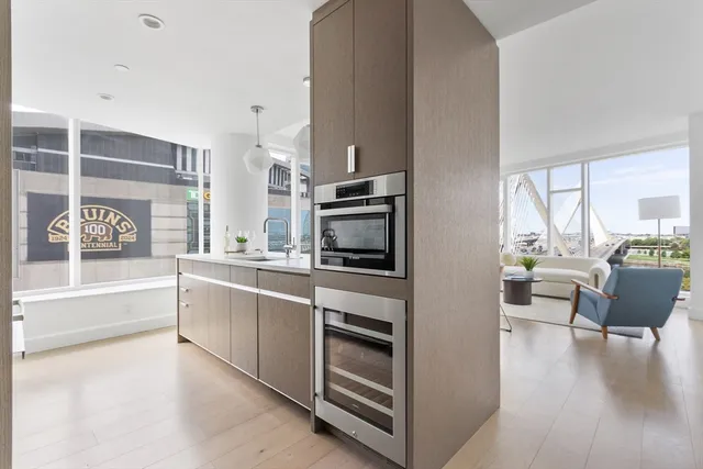 a kitchen with stainless steel appliances a stove top oven and a refrigerator