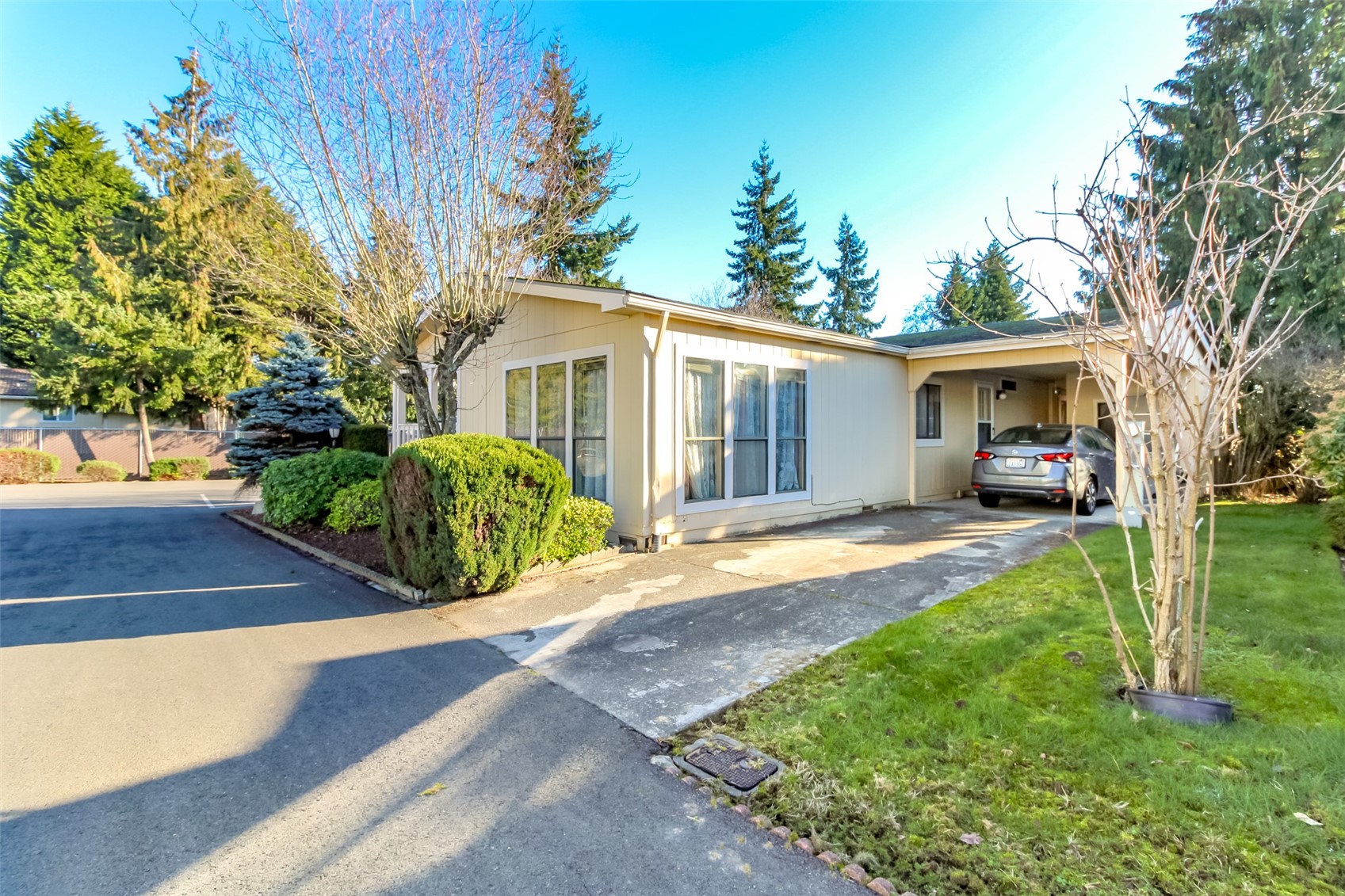 2611 South 288th Street, Unit 74 Federal Way, WA 98003 - Photo 20 of 30 a front view of a house with a yard and potted plants