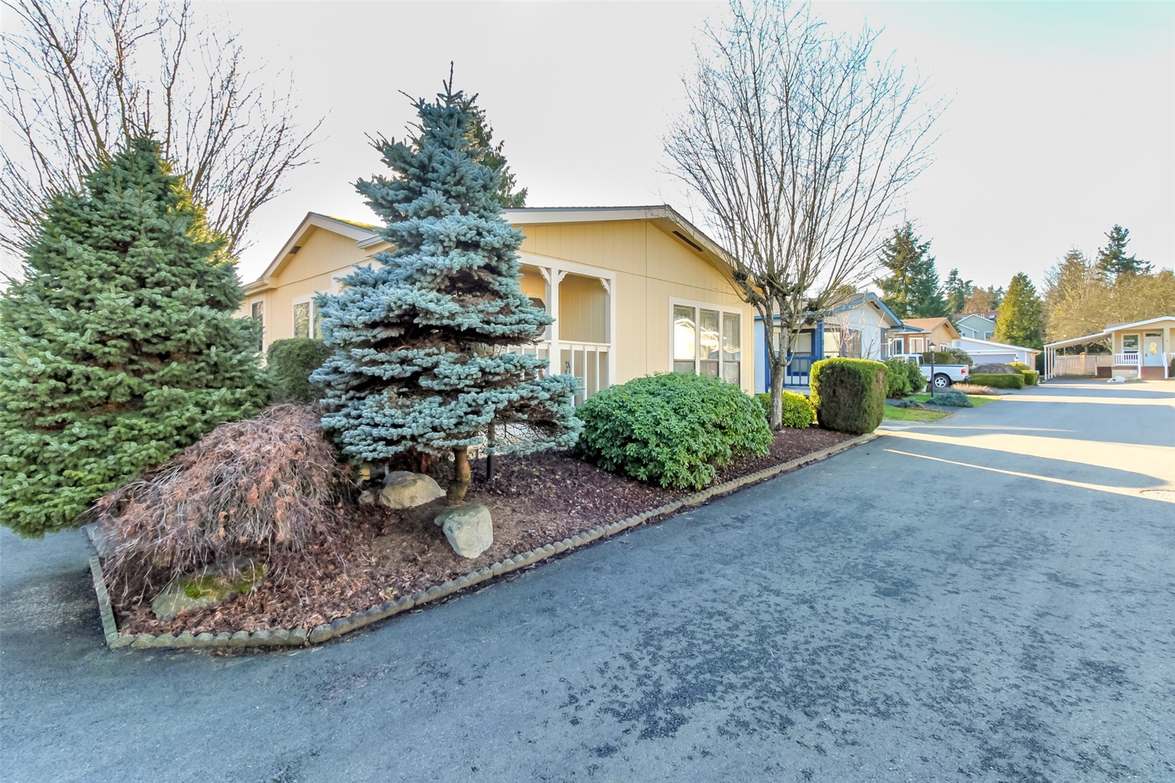 2611 South 288th Street, Unit 74 Federal Way, WA 98003 - Photo 2 of 30 a view of a house with a yard and garage