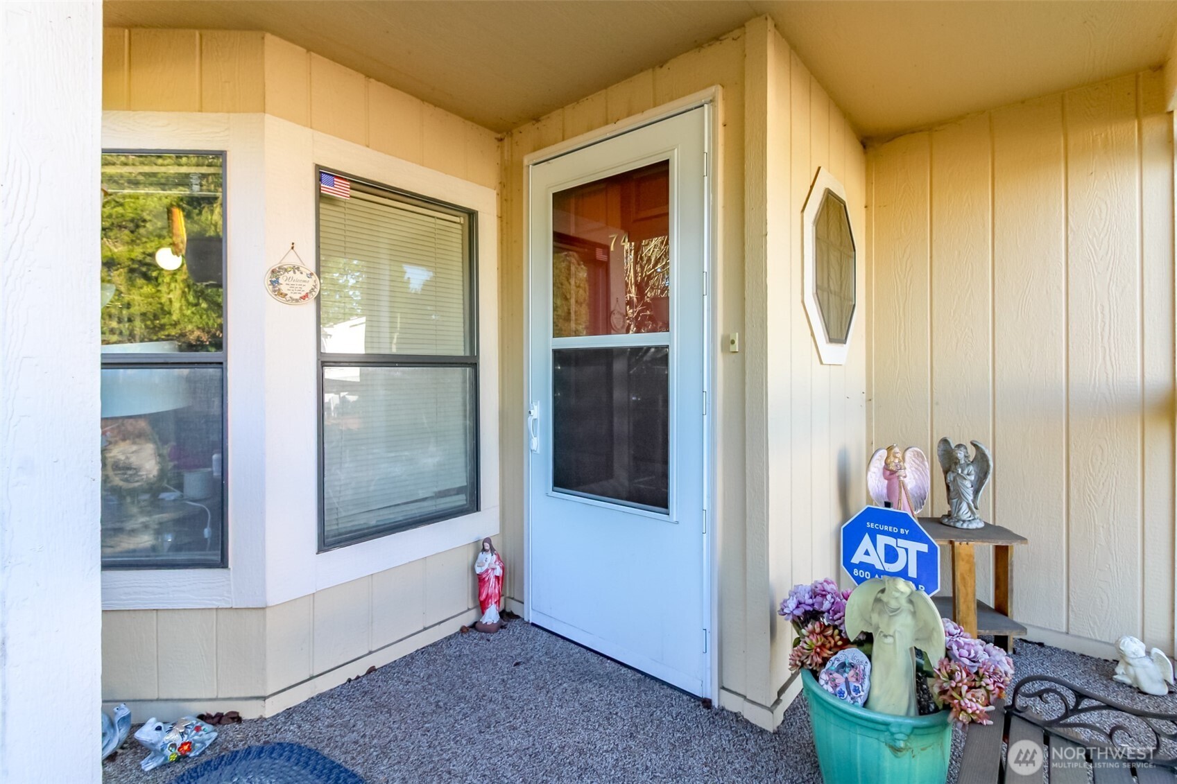 2611 South 288th Street, Unit 74 Federal Way, WA 98003 - Photo 3 of 30 a room with painting on the wall and a window