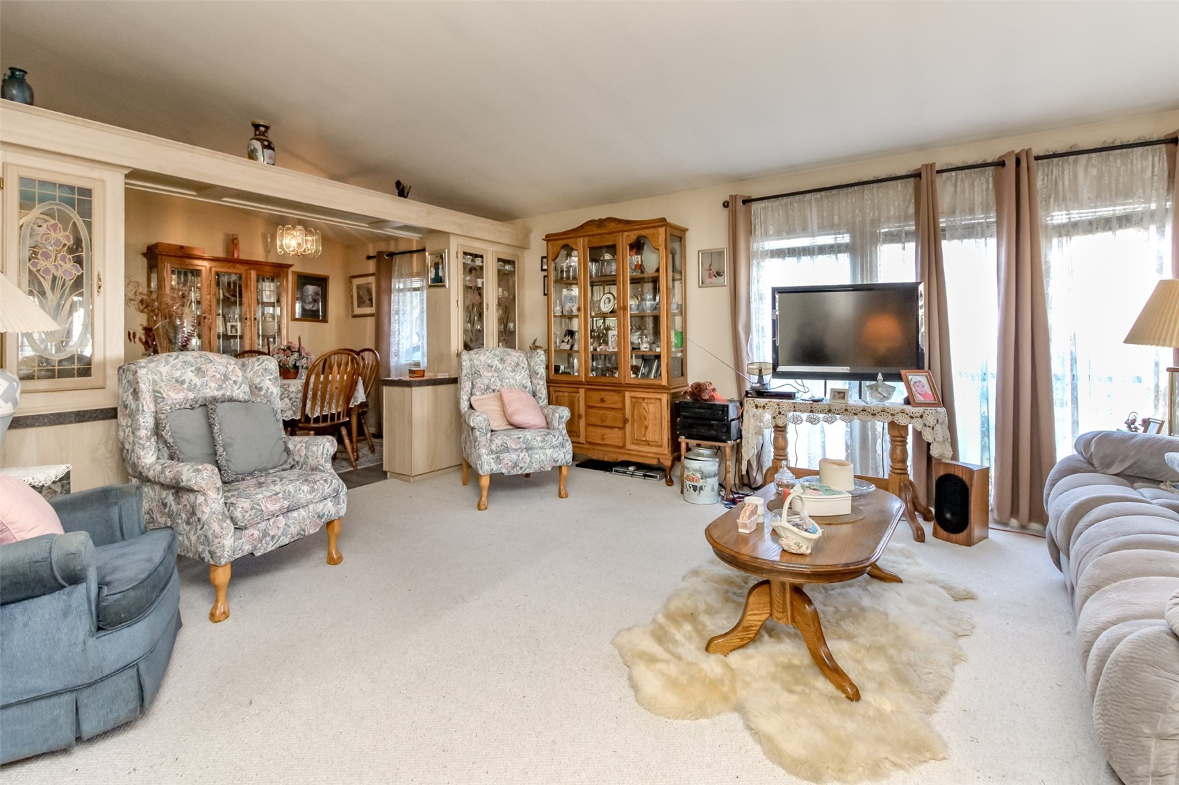 2611 South 288th Street, Unit 74 Federal Way, WA 98003 - Photo 6 of 30 a living room with furniture a flat screen tv and a large window