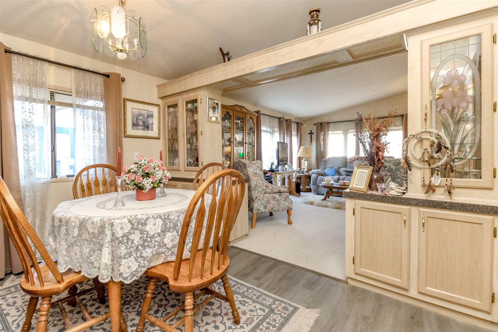 2611 South 288th Street, Unit 74 Federal Way, WA 98003 - Photo 9 of 30 a dining room with furniture a chandelier and wooden floor