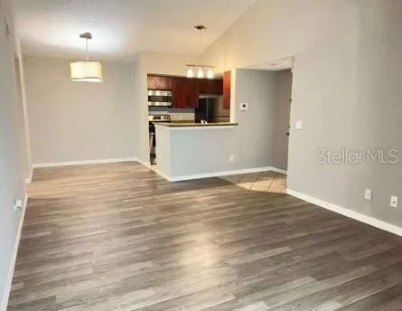 a view of a kitchen with wooden floor and a sink