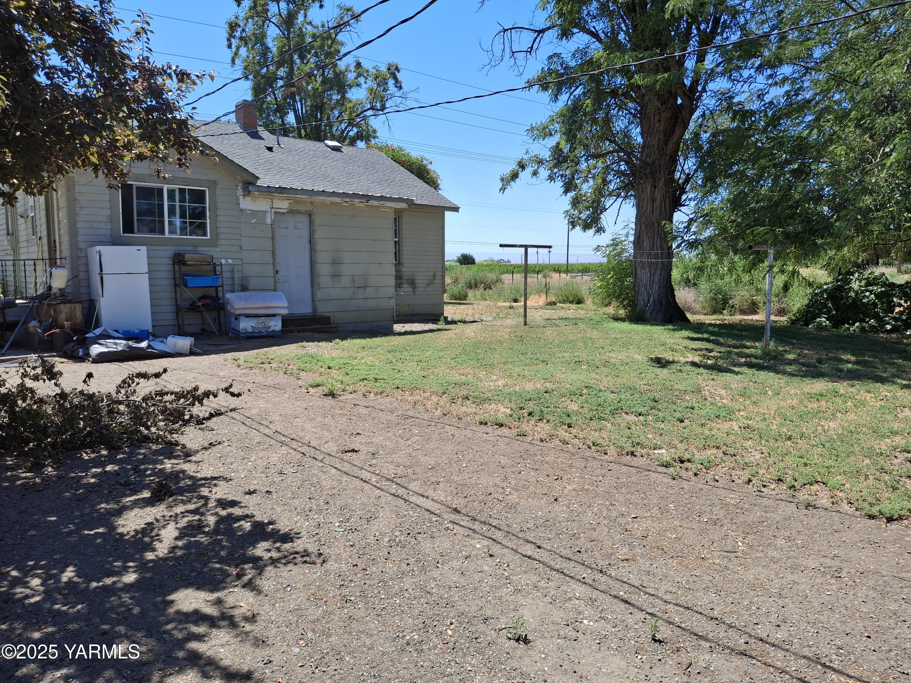1371 Alexander Road Sunnyside, WA 98944 - Photo 1 of 5 a view of a yard with a house and a tree