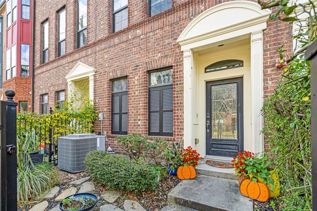 a front view of a house with a chairs and potted plant