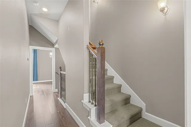 a view of entryway and hall with wooden floor