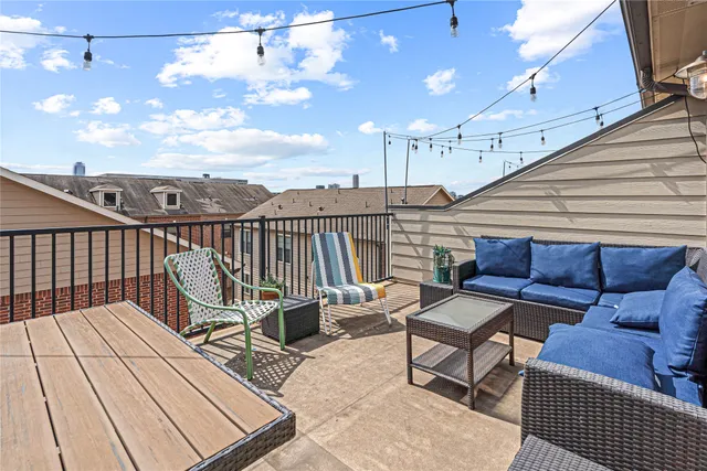 a view of a roof deck with furniture