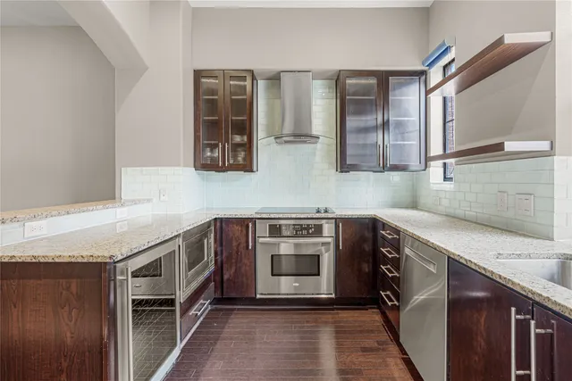 a kitchen with stainless steel appliances granite countertop a stove and a sink