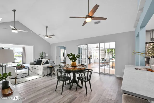 a living room with furniture a fireplace and a ceiling fan