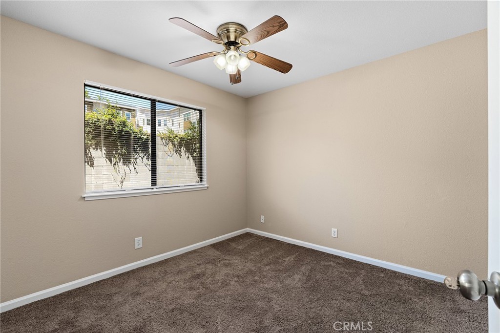 1114 Nord Avenue, Unit 17 Chico, CA 95926 - Photo 15 of 40 an empty room with windows and fan