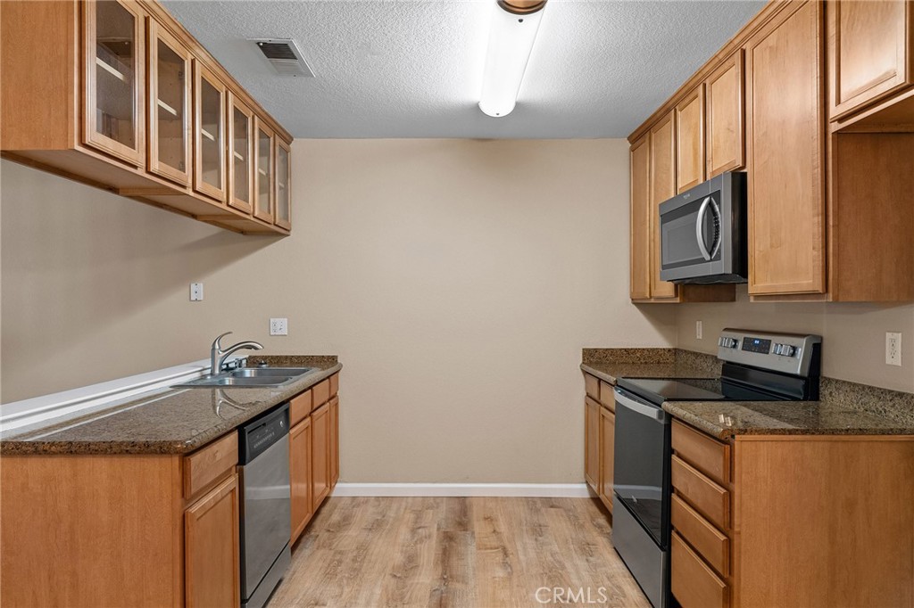 1114 Nord Avenue, Unit 17 Chico, CA 95926 - Photo 7 of 40 a kitchen with stainless steel appliances granite countertop a sink stove and cabinets