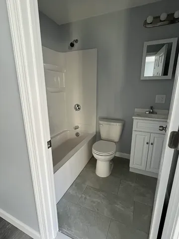 a bathroom with a toilet and a bathtub