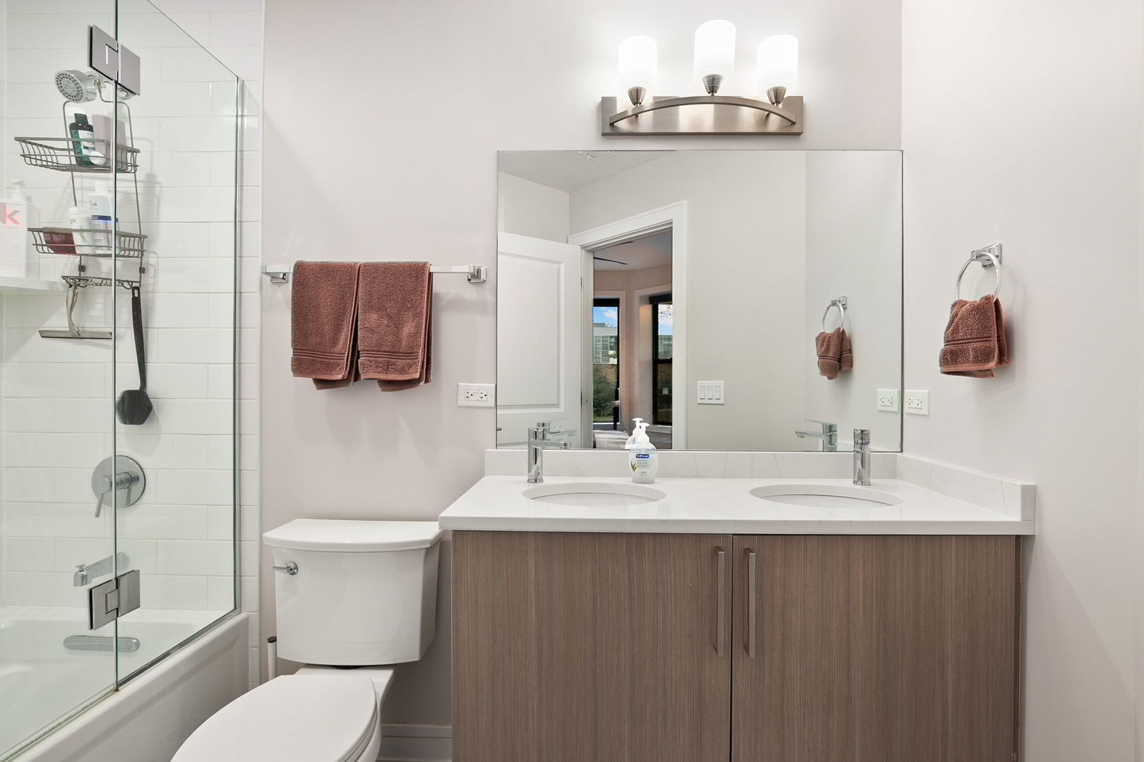 807 West Bradley Place, Unit 2 Chicago, IL 60613 - Photo 18 of 26 a bathroom with a sink vanity mirror and toilet