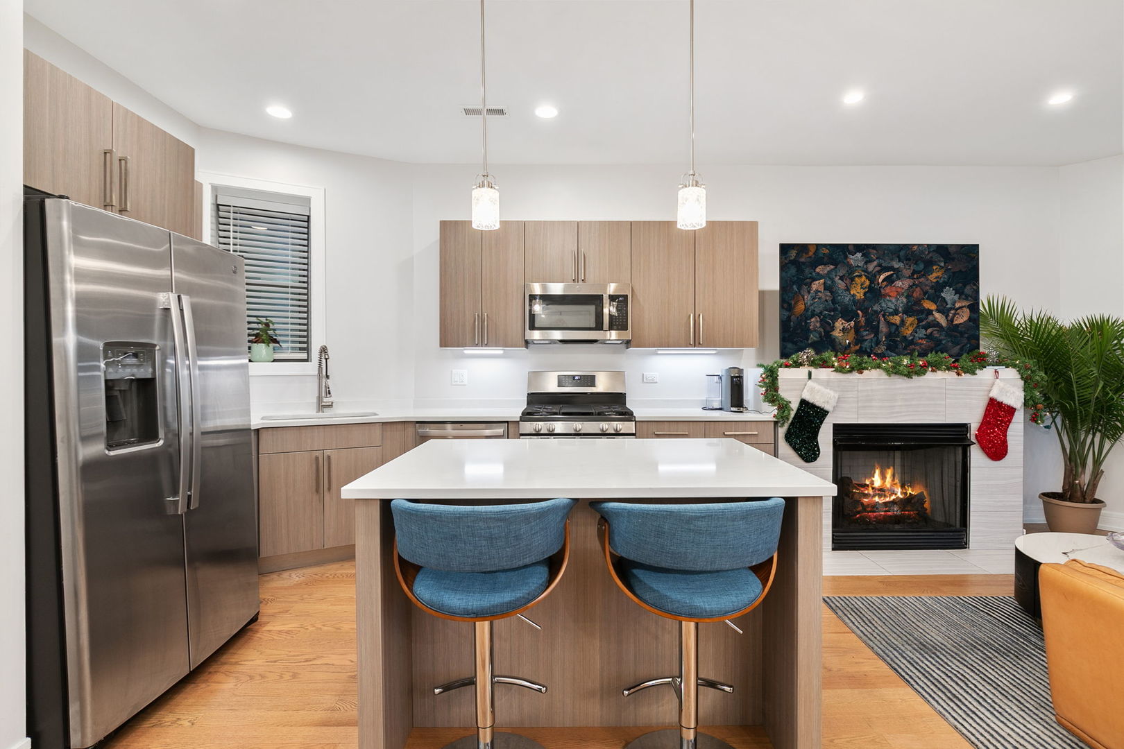 807 West Bradley Place, Unit 2 Chicago, IL 60613 - Photo 7 of 26 a kitchen with stainless steel appliances granite countertop a stove a refrigerator and a fireplace