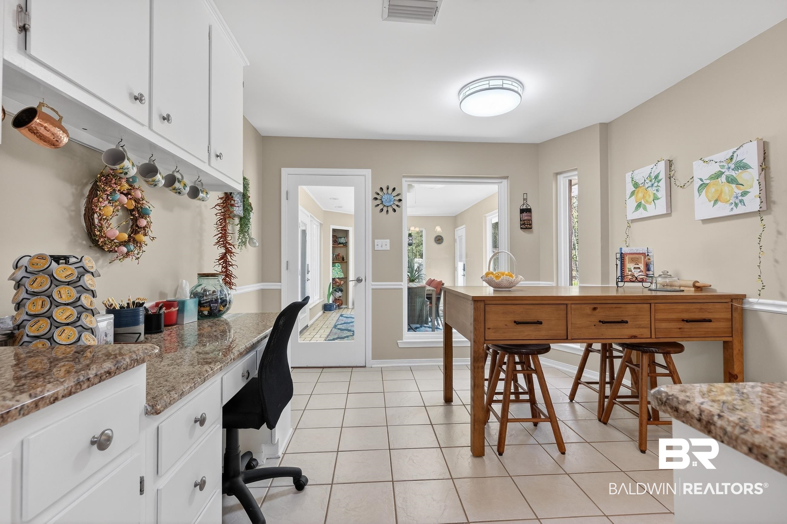 1271 Spring Valley Drive South Mobile, AL 36693 - Photo 20 of 56 Kitchen featuring a desk, white cabinetry, and light tile patterned flooring