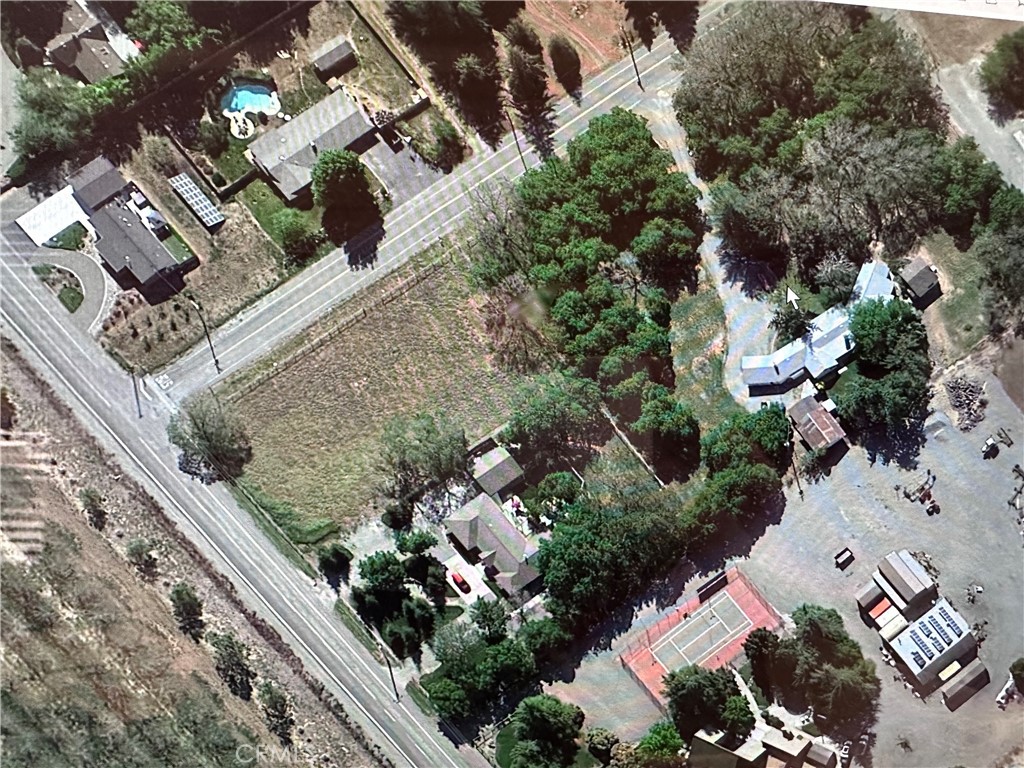 an aerial view of multiple houses with yard