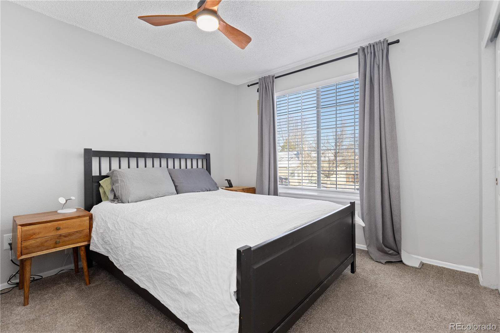 9364 Cattail Court Highlands Ranch, CO 80126 - Photo 14 of 31 a bedroom with a bed and window