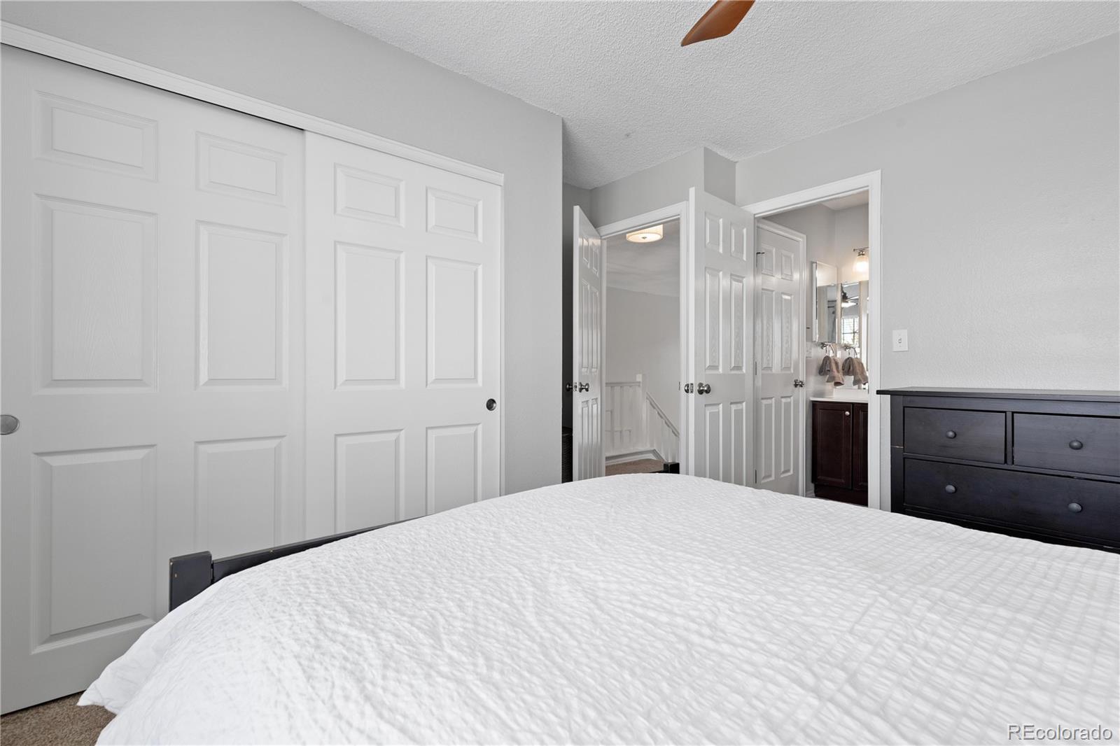 9364 Cattail Court Highlands Ranch, CO 80126 - Photo 15 of 31 a bedroom with a bed and a mirror