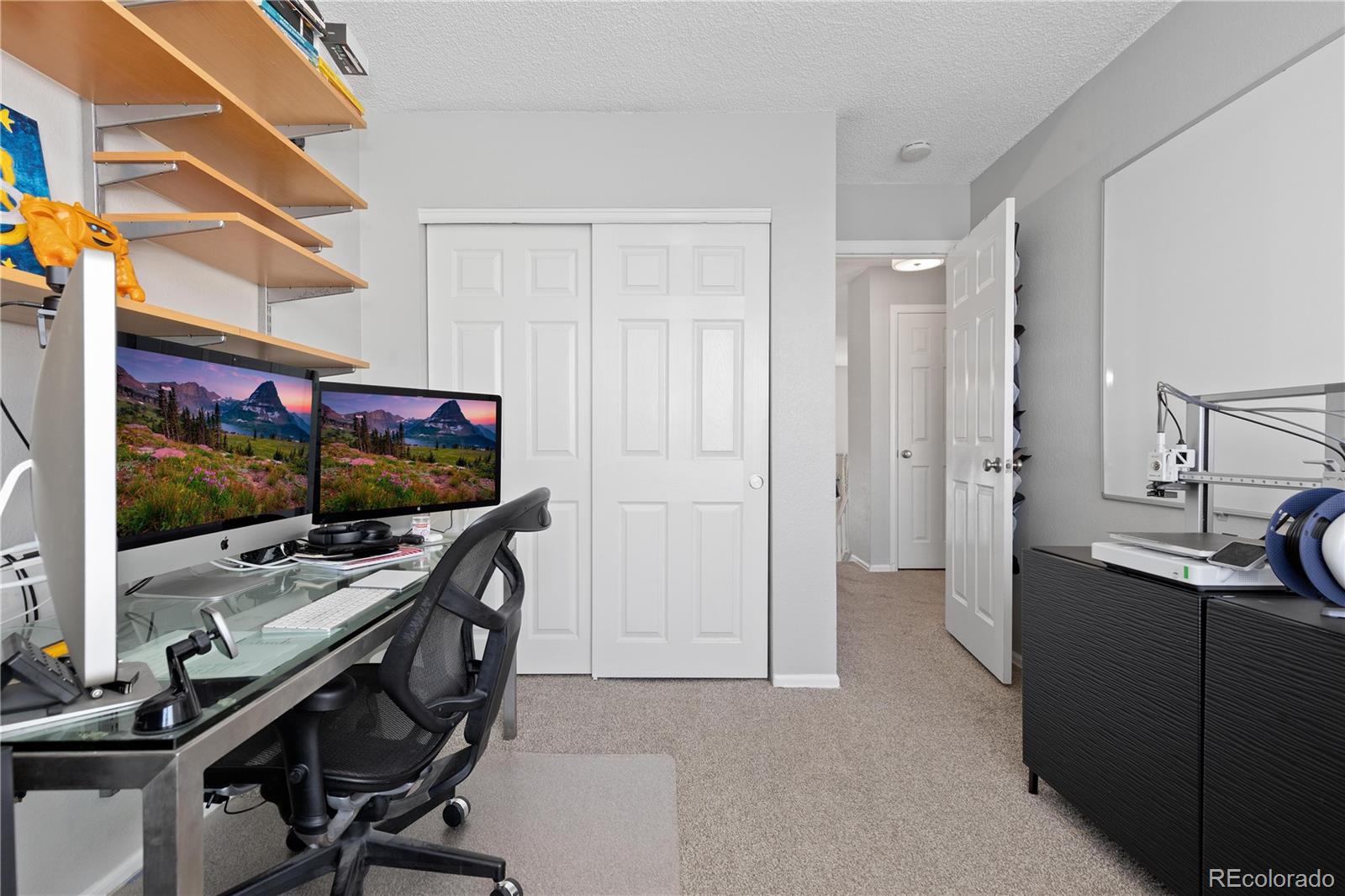 9364 Cattail Court Highlands Ranch, CO 80126 - Photo 17 of 31 a room with a flat screen tv and a refrigerator