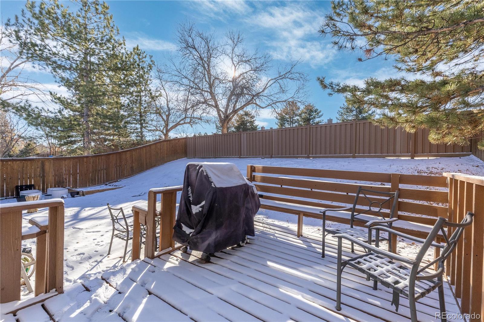 9364 Cattail Court Highlands Ranch, CO 80126 - Photo 24 of 31 a view of a patio with table and chairs with wooden floor and fence and a couple of chairs