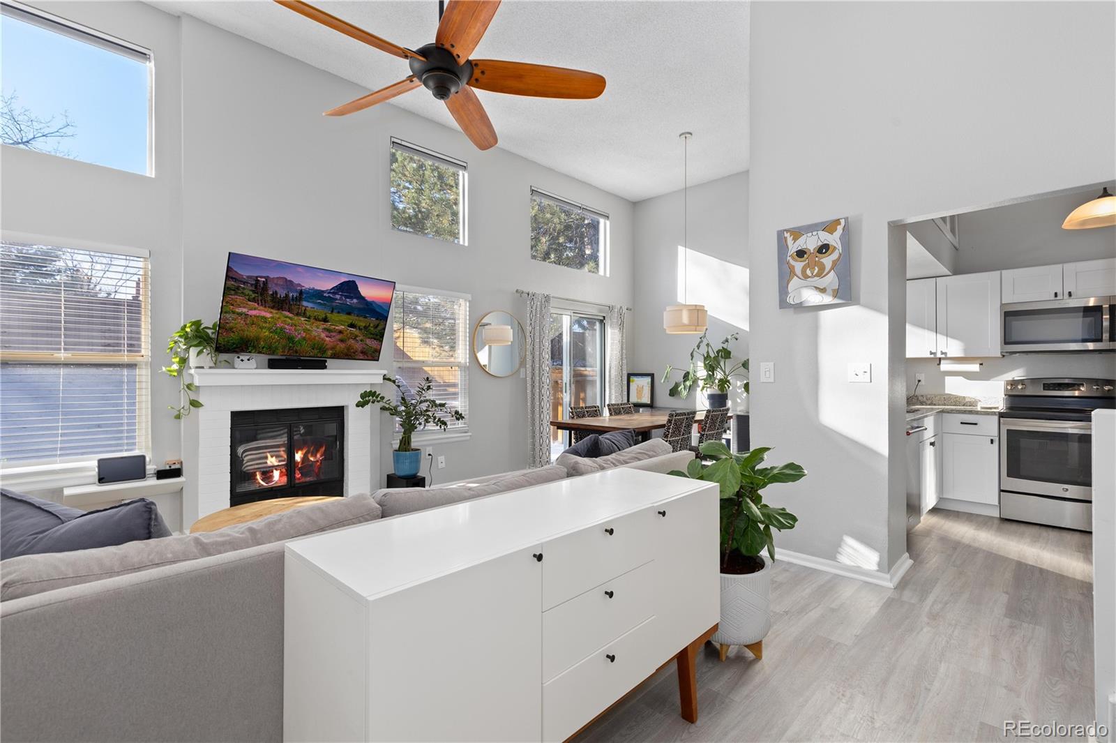 9364 Cattail Court Highlands Ranch, CO 80126 - Photo 5 of 31 a living room with furniture a fireplace and kitchen view