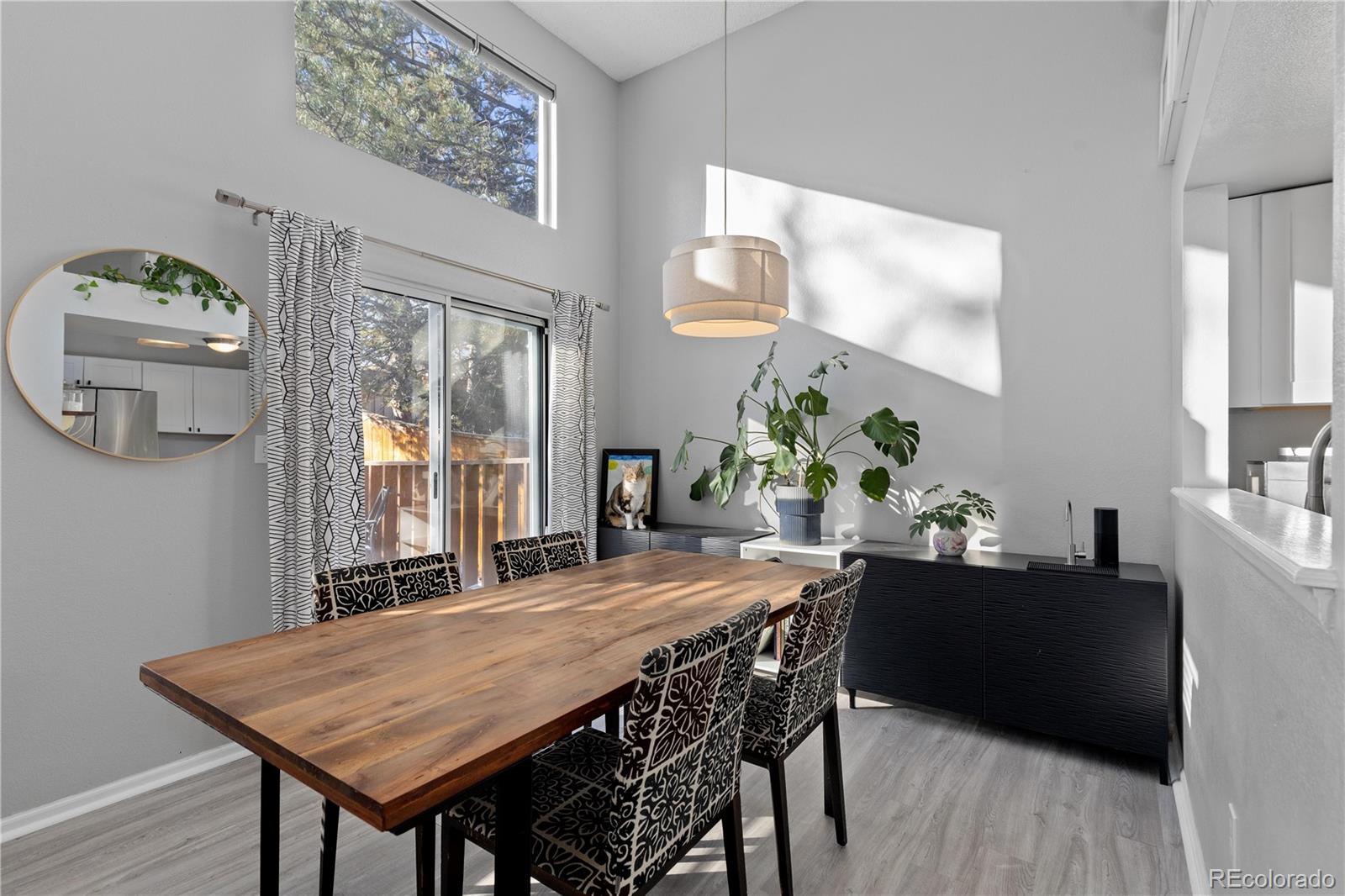 9364 Cattail Court Highlands Ranch, CO 80126 - Photo 9 of 31 a dining room with a wooden table and chairs