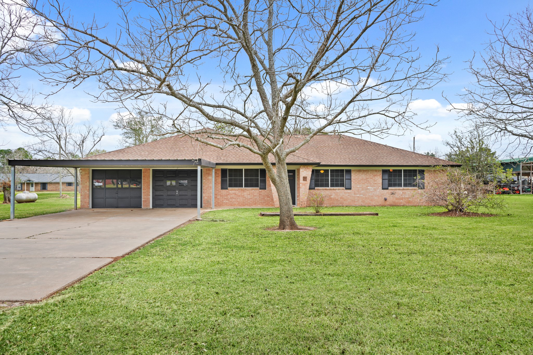 1438 County Road 348 Brazoria, TX 77422 - Photo 1 of 25 a front view of a house with a garden
