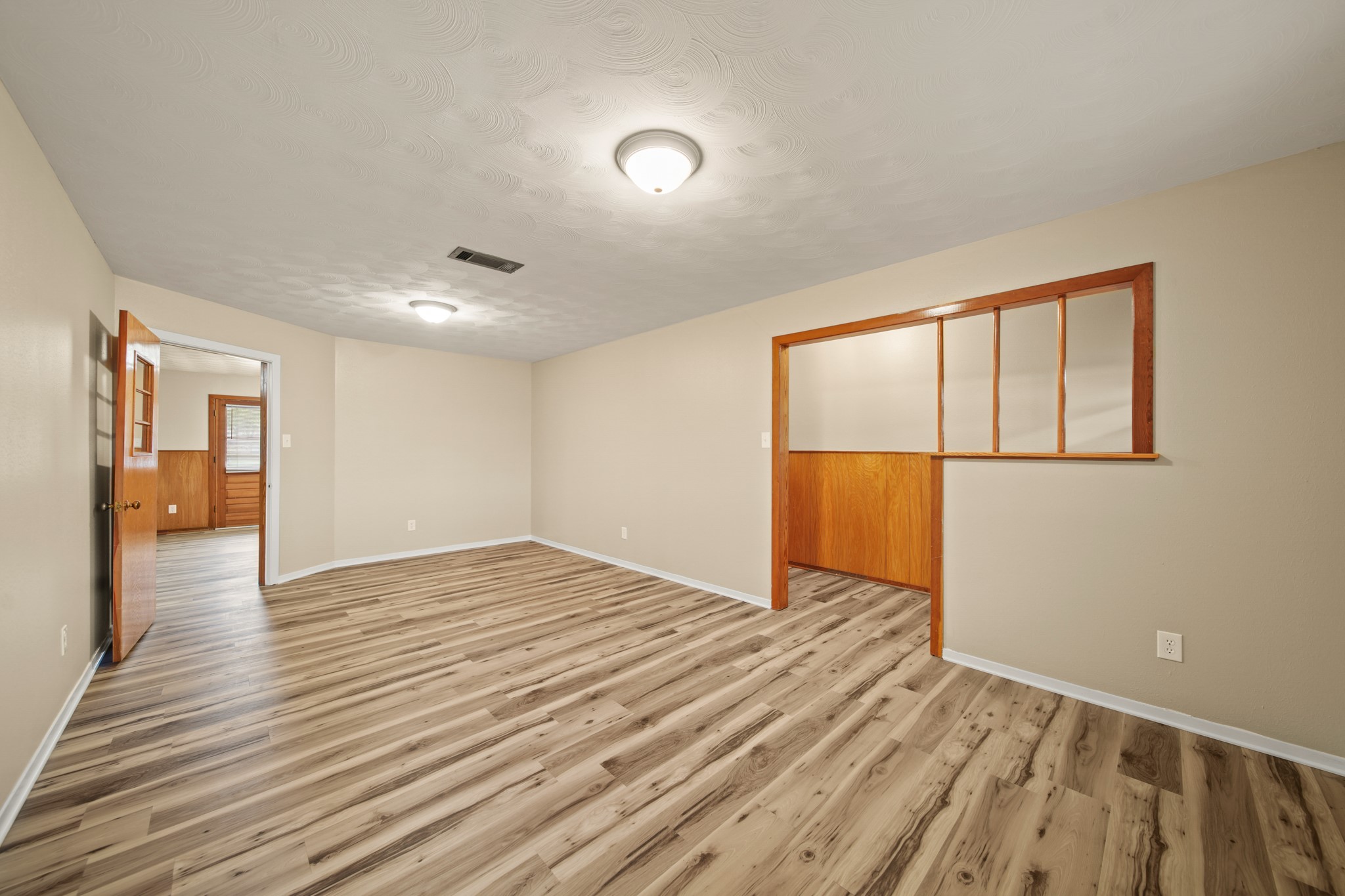1438 County Road 348 Brazoria, TX 77422 - Photo 11 of 25 a view of an empty room with wooden floor and a window