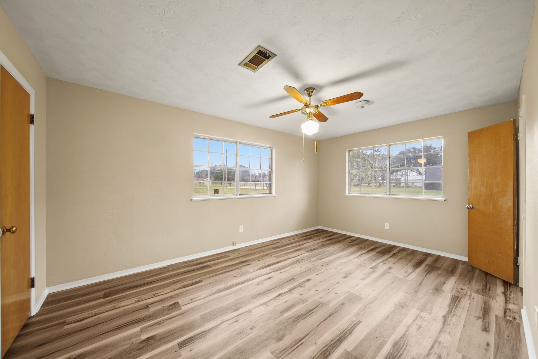 1438 County Road 348 Brazoria, TX 77422 - Photo 18 of 25 a view of an empty room with wooden floor and a window