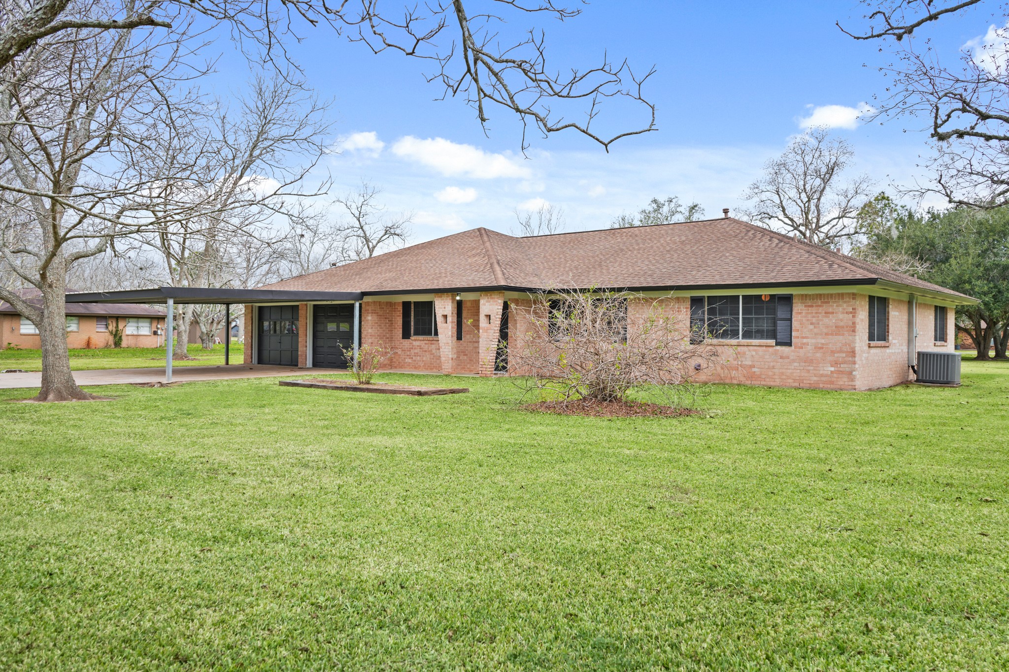 1438 County Road 348 Brazoria, TX 77422 - Photo 2 of 25 a view of a yard in front of a house with large trees