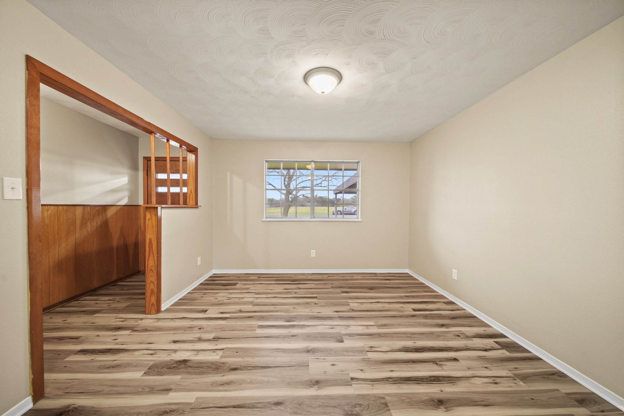 1438 County Road 348 Brazoria, TX 77422 - Photo 10 of 25 a view of an empty room with wooden floor and a window