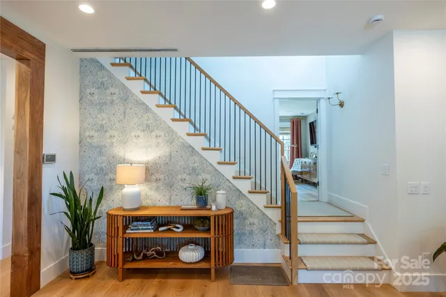 a view of entryway and hall with wooden floor