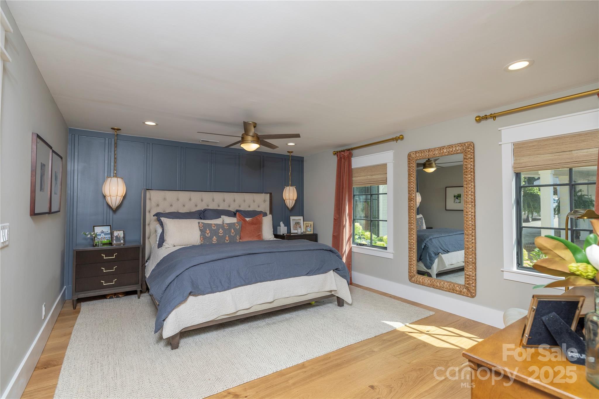 18353 John Connor Road Cornelius, NC 28031 - Photo 14 of 47 a bedroom with a bed mirror and a large window