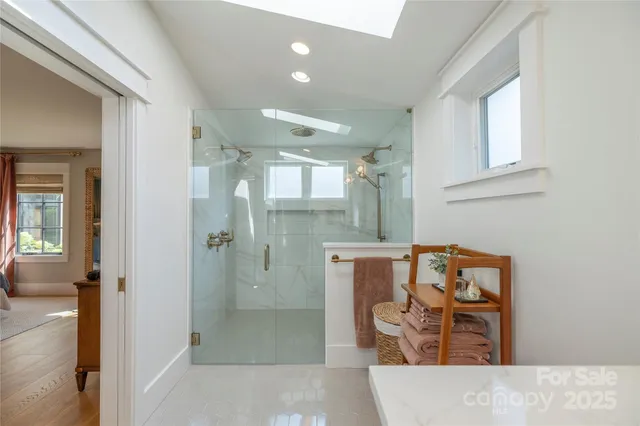 a bathroom with a tub shower sink and mirror