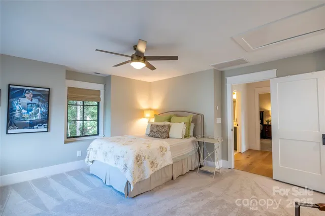 a bedroom with a large bed and a chandelier