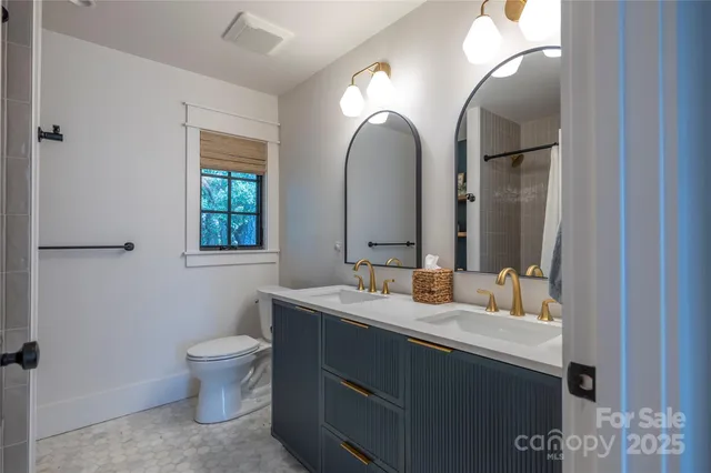 a bathroom with 2 sink and a mirror