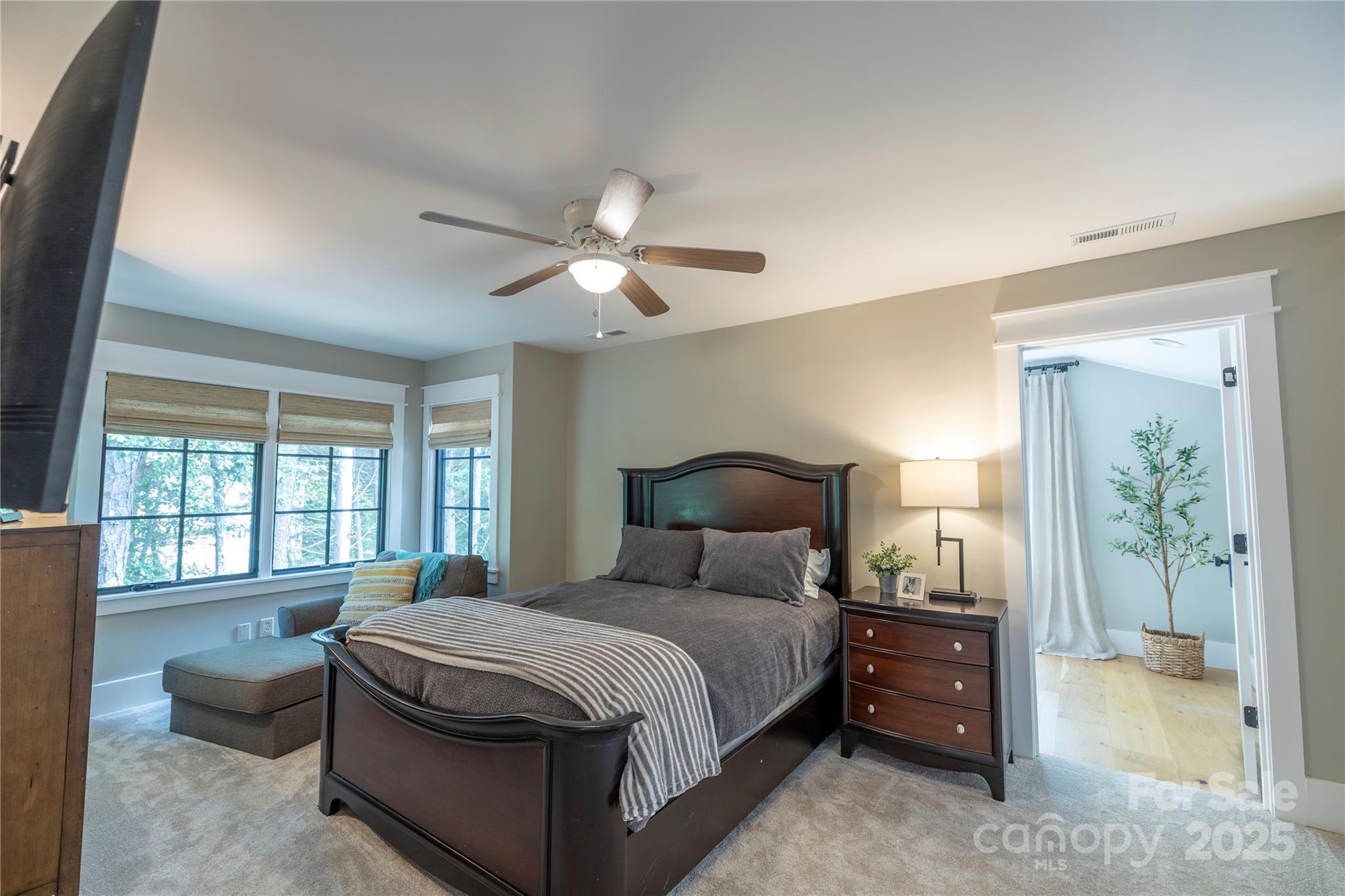 18353 John Connor Road Cornelius, NC 28031 - Photo 21 of 47 a bedroom with a large bed and a chandelier