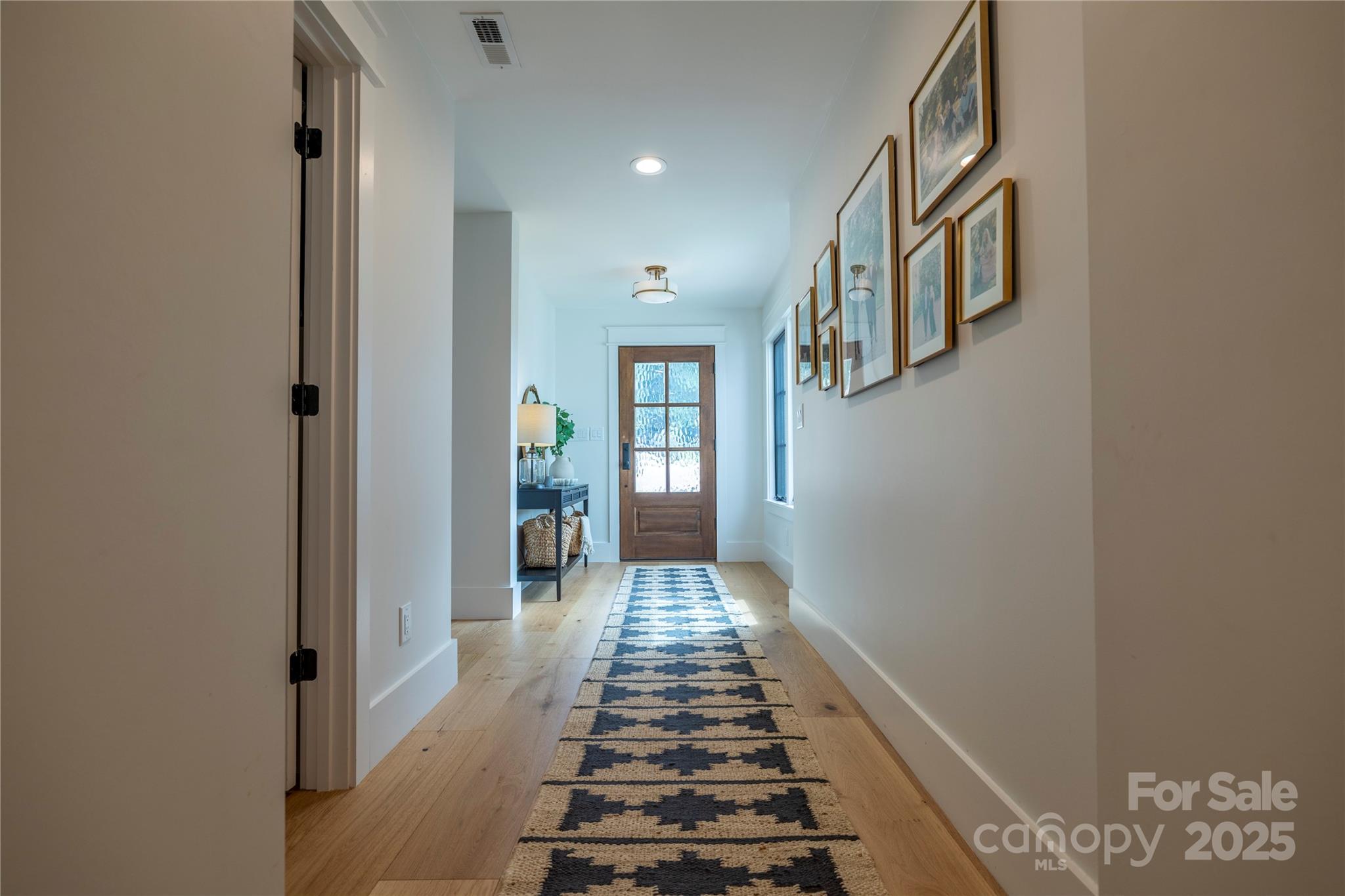 18353 John Connor Road Cornelius, NC 28031 - Photo 24 of 47 a view of a hallway with wooden floor and staircase