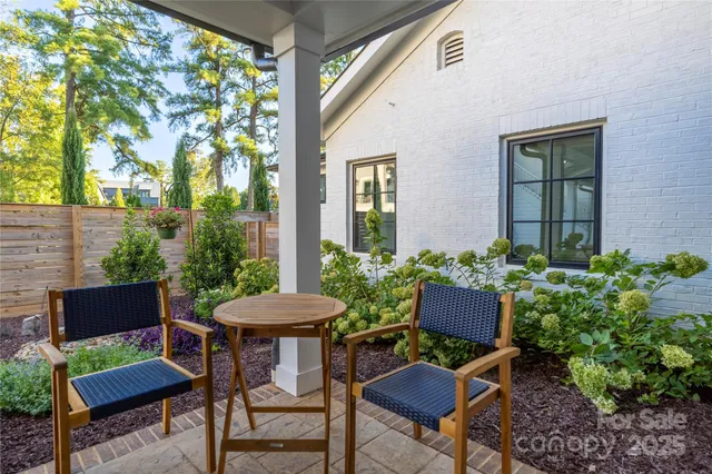 a view of a chairs and table in a backyard