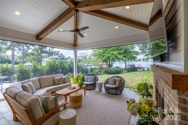 a living room with patio furniture and a garden