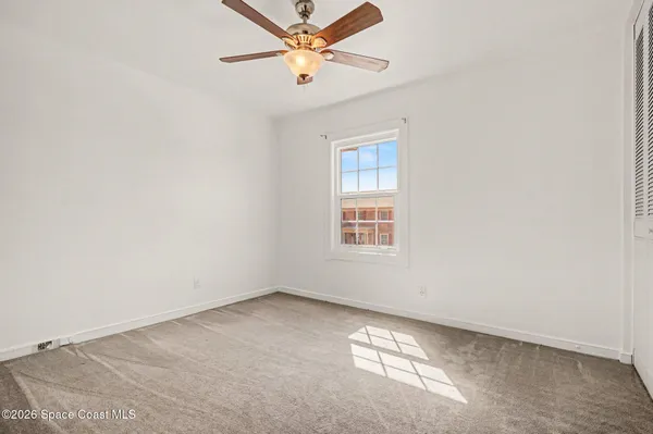 a view of a house with wooden floor and a fence